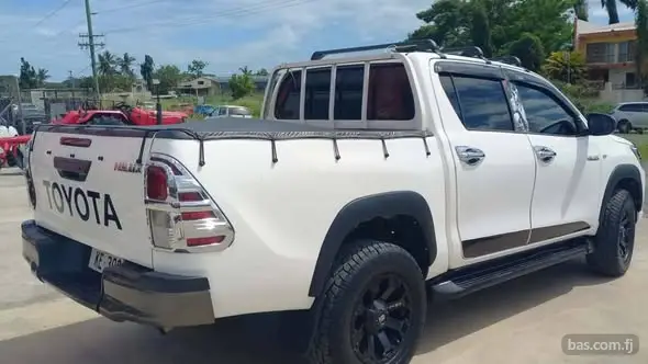 White Toyota Hilux pickup truck.